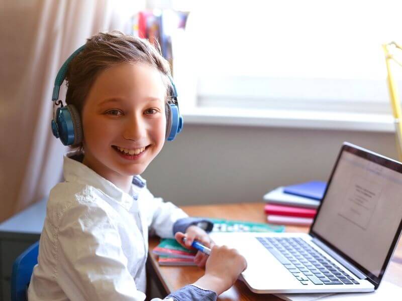 boy infront of computer doing online dyslexia tutoring