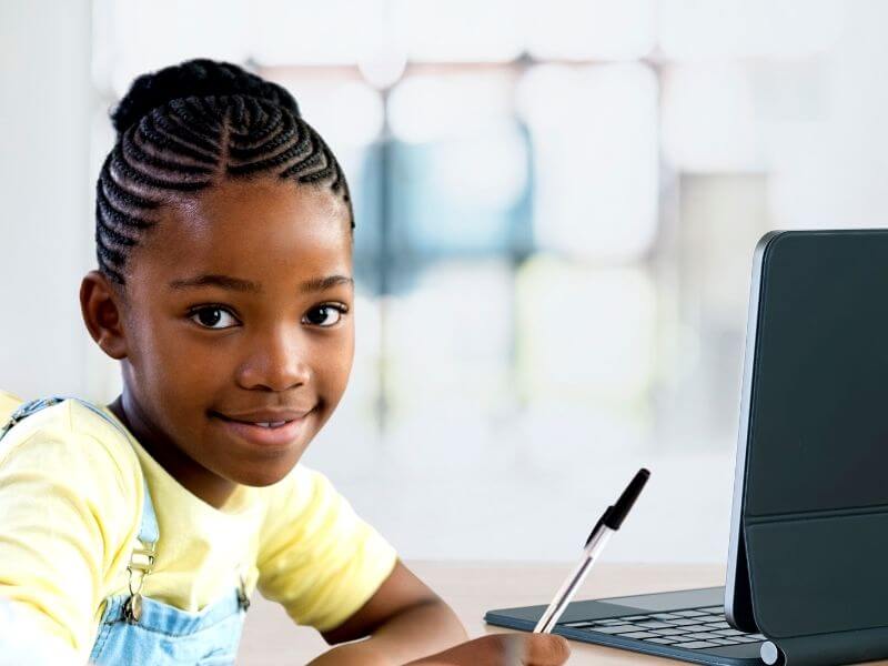 girl doing virtual tutoring in front of computer