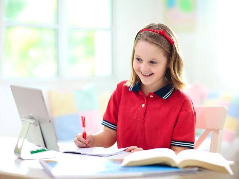 girl in front of computer doing dyslexia tutoring online
