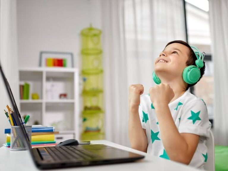 happy boy in front of computer developiong a relationship with his online tutor coach